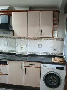 a kitchen with a washer and a washing machine at San Juan in Alborache