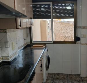 a kitchen with a sink and a washing machine at San Juan in Alborache +16 photos