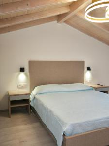 a bedroom with a large bed and two night stands at Anna's Corfu Escape Apartments 1 in Agios Ioannis
