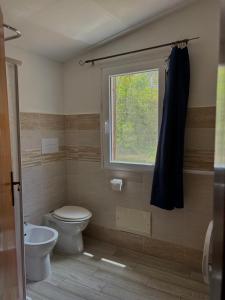 un bagno con wc e finestra di Agrustos Paradise a Budoni Altre 26 foto
