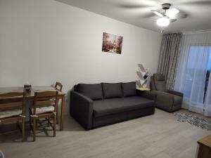 a living room with a couch and a table at Lorena from White Tower in Ploieşti +13 photos