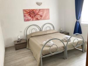 a bedroom with a bed with a pink flower on the wall at Agrustos Paradise in Budoni