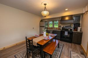 a kitchen with a wooden table and a dining room at Country Feel with Downtown Convenience - WiFi - 10 Min to Red River Gorge & Natural Bridge in Stanton