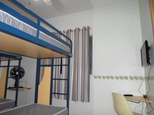 a bedroom with a bunk bed with a desk and a chair at Hostel São José Dos Campos in São José dos Campos