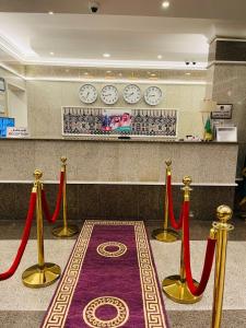 a room with red ribbon barriers and a red carpet at Lamasat Al Ajnaha Serviced Apartments in Abha