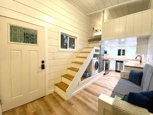 a tiny house with stairs leading to a kitchen at Cozy Cache Vista Tiny House with Summer Rates in Tetonia