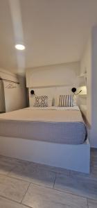 a bedroom with a large white bed with two pillows at Naousa's Melody in Naousa