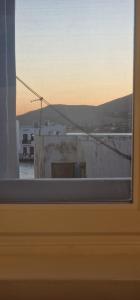 a window with a view of a city at Naousa's Melody in Naousa