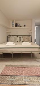 a large bed in a room with a rug at Naousa's Melody in Naousa +39 photos