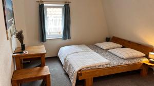 a bedroom with a bed with two pillows and a window at Hostel Ziegenrück in Ziegenrück