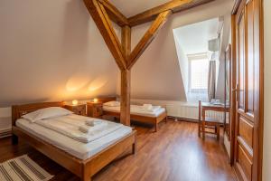 a bedroom with a bed and a desk and a window at Pensiunea Bastion - La Strada - in Sighişoara