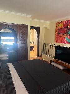 a bedroom with a bed and a painting on the wall at Domina Coral Bay Harem Luxury in Banī Ghālib +46 photos