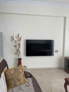a living room with a tv on a wall at Klara's Apartment in Fier