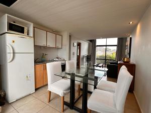 a kitchen with a table and chairs and a refrigerator at Casco Antiguo 7 in Chascomús +6 photos
