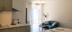 a kitchen with a blue chair and a living room at Salvia, Cinque Terre in Vernazza