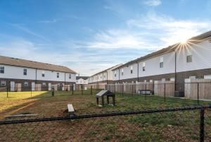 a group of buildings with a playground in a yard at Arte Luxury Townhomes B1 I Comfy 2 Bed 25 Bath in Oak Grove