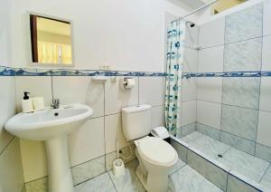 a bathroom with a toilet and a sink and a shower at Departamento Céntrico de Estreno en Pucallpa in Pucallpa +13 photos
