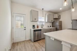 a kitchen with white cabinets and a sink and a refrigerator at Arte Luxury Townhomes F6 I Comfy 2 Bed 25 Bath in Oak Grove