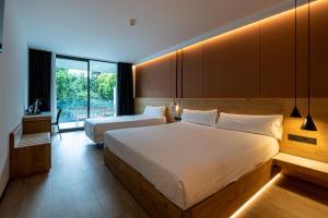 a hotel room with two beds and a balcony at Hotel Silgar 92 in Sanxenxo +74 photos