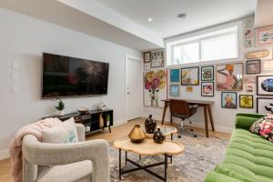 a living room with a couch and a tv at Santuario Kensington - Inner City Escape in Calgary +24 photos