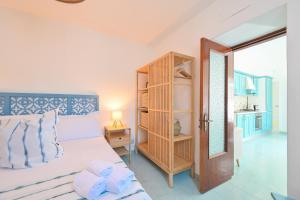 a bedroom with a bed and a open door at Chiaia Di Rose Seaside Suite in Sant'Angelo D'Ischia
