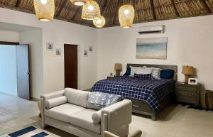 a bedroom with a bed and a couch and a bed at The sunrises are lovely, and the privacy is exceptional in Sipacate