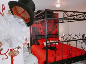 a bedroom with a red bed with a black bed frame at SUITE THE BLESSING "Where Heaven Touches Earth" in Bruges