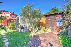 a backyard with a wooden shed and a garden at Casa Fra Gli Ulivi with Private Pool - Chicca in Ameglia