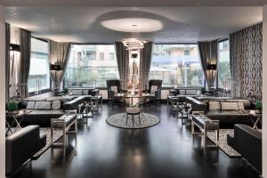 a lobby with couches and tables and windows at LHP Hotel Santa Margherita Palace & SPA in Santa Margherita Ligure