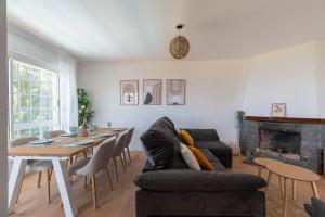 a living room with a table and a couch at Villa Cies con Piscina in Vigo
