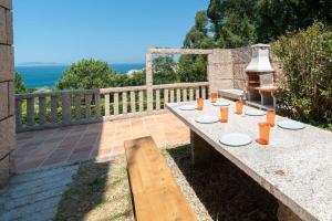 a table with plates on it on a patio at Villa Cies con Piscina in Vigo