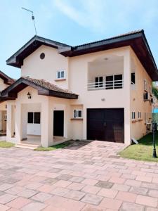 a house with a driveway in front of it at Stylish 3 bedroom House Near Airport & Marina Mall in Accra