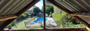 a view of a swimming pool from a window at NEWEN POSADA in La Consulta +11 photos