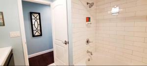 a bathroom with a tub and a shower stall at Romantic Tropical Retreat with a Private Hot Tub! in Long Beach +6 photos