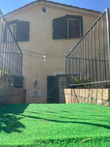 a house with a green lawn in front of it at L'Albero della vita in Piano di Sorrento