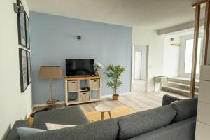 a living room with a couch and a tv at Quinta Sao Roque in São Roque