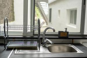 a kitchen sink with a dish drying rack next to a window at Quinta Sao Roque in São Roque +91 photos