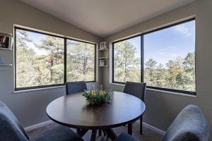 a room with a table and chairs and windows at New Listing - Cedar Escape -Close to Lakes & Golf in Show Low
