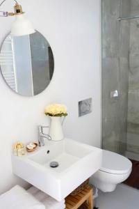 a white bathroom with a sink and a mirror at Sparrow Sintra Nest in Sintra