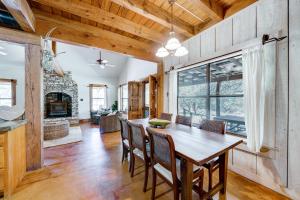 a dining room with a table and a fireplace at Swim, Hike and Unwind Serene Hill Country Retreat in Kerrville