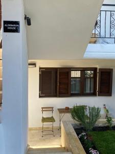 a chair sitting on a patio with a table at Aldebaran house in Nea Fokea