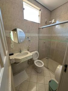 a bathroom with a toilet and a sink and a shower at Aruanã Palace Hotel in Colíder +19 photos
