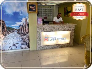 a man sitting at a counter in a restaurant at Silver Tower Family Apart Otel in Kuşadası +105 photos