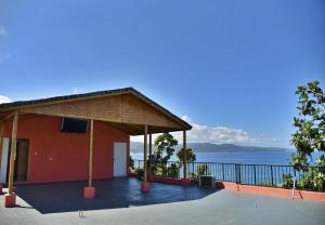 a red building with a view of the water at LS Stonethrow - Sapphire Deluxe in Montego Bay