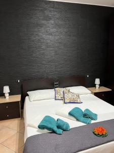 a bed with two towels and two pillows on it at Profumo di marzamemi in Marzamemi