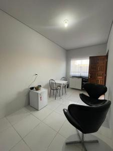 a living room with a table and chairs at Apto entrada individual 1 in Sinop