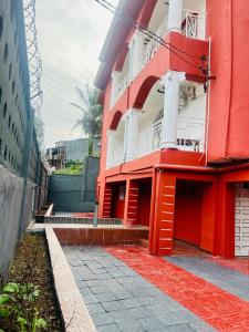 a red and white building with a red rug in front of it at Mountain View Villa in Freetown