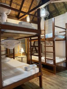 a group of bunk beds in a room at La Perla Hostel and Cabins in Las Tunas