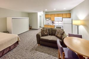 a room with a couch and a table and a kitchen at 107 Ocean Picture Academy - Beachfront Condo - Pool Hot Tub & Full Kitchen in Lincoln City +8 photos