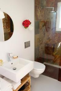 a bathroom with a sink and a toilet and a shower at Sparrow Sintra Nest in Sintra